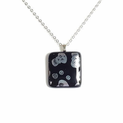 Dichroic silver sugar skulls on black fused glass necklace