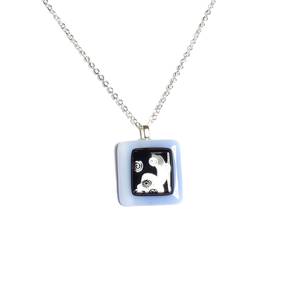Dichroic silver skulls on light blue fused glass pendant necklace